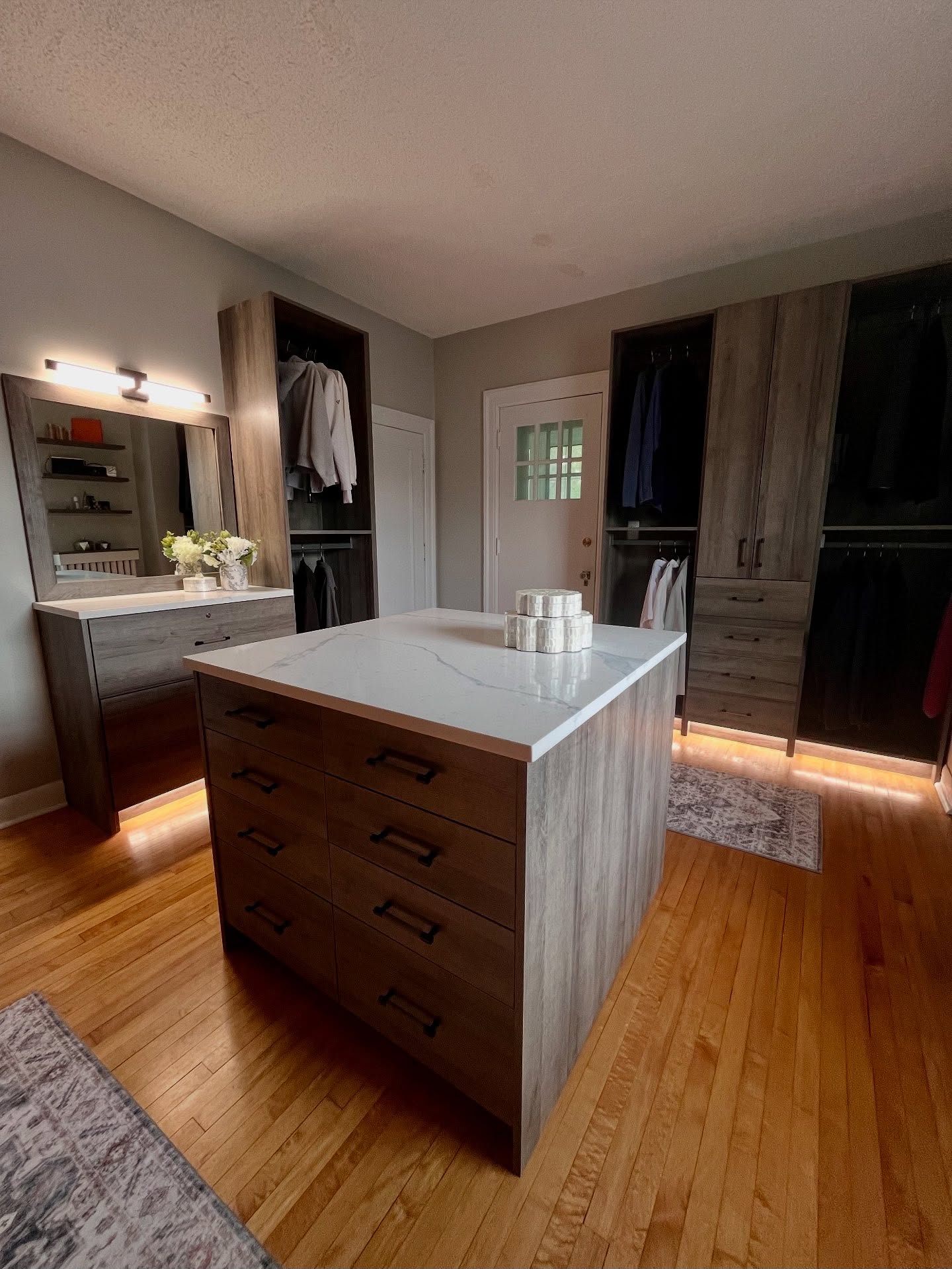 Open hanging zone beside closed wardrobe drawers in a Winnipeg closet design