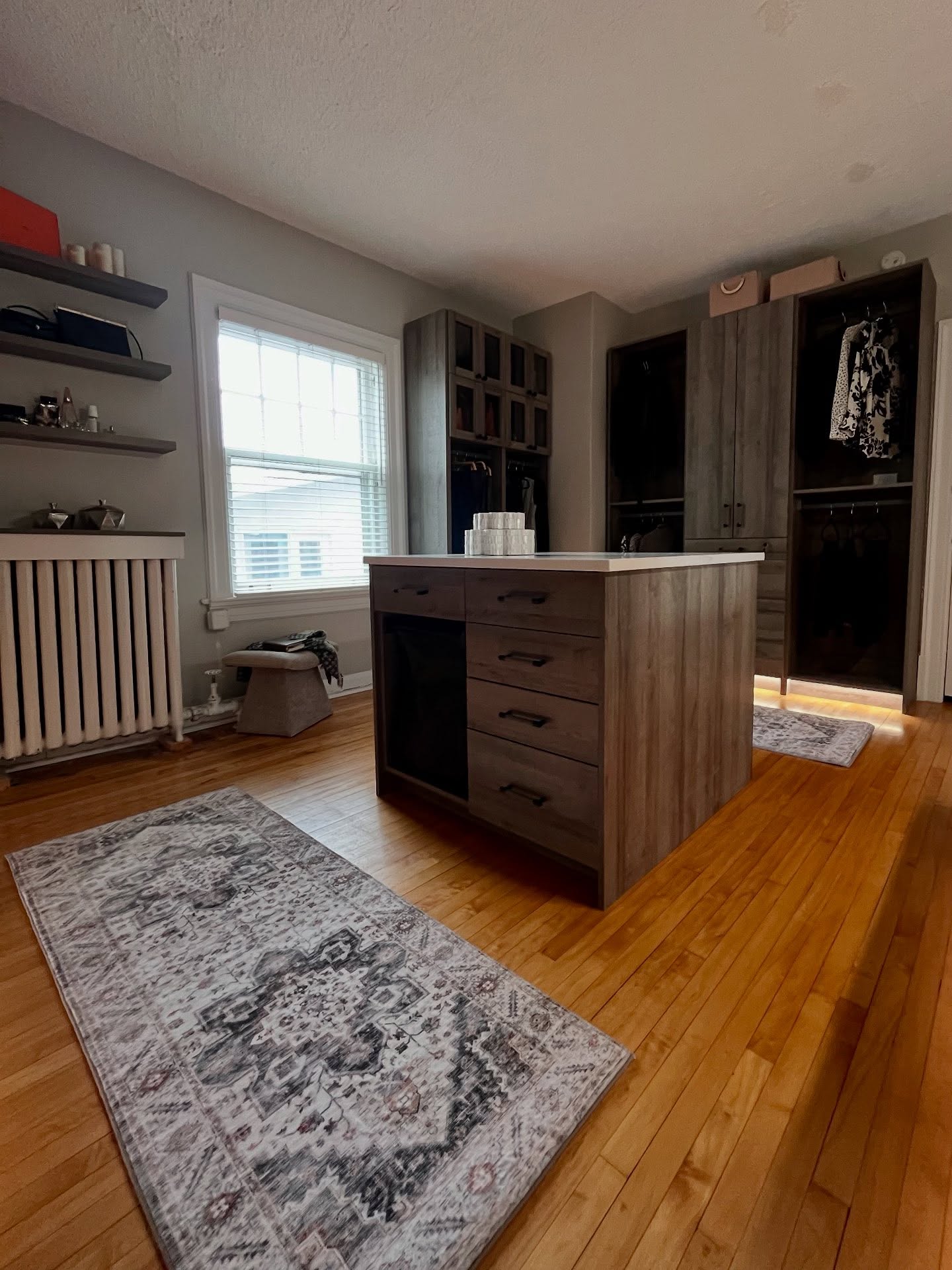Tall wardrobe cabinets with warm lighting on the wood grain