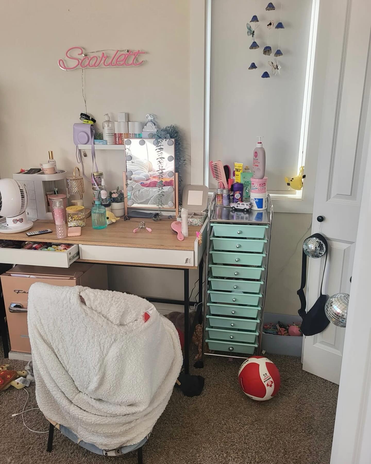 Homework desk in a girls bedroom with storage within reach