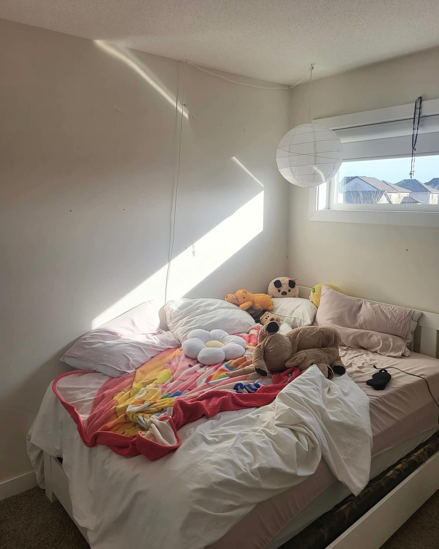 Girls bedroom bed and full room view with a soft pink and cream palette