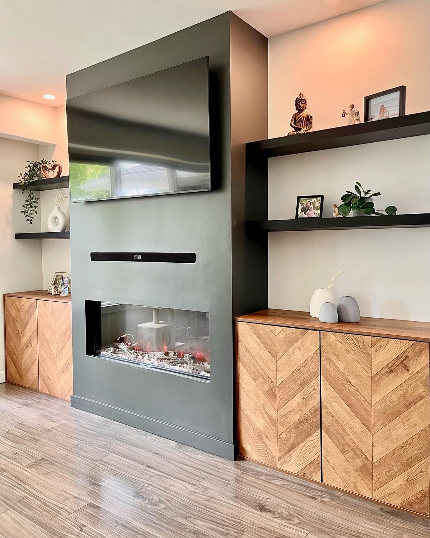Wide view of the refreshed Winnipeg living room with new flooring and feature wall