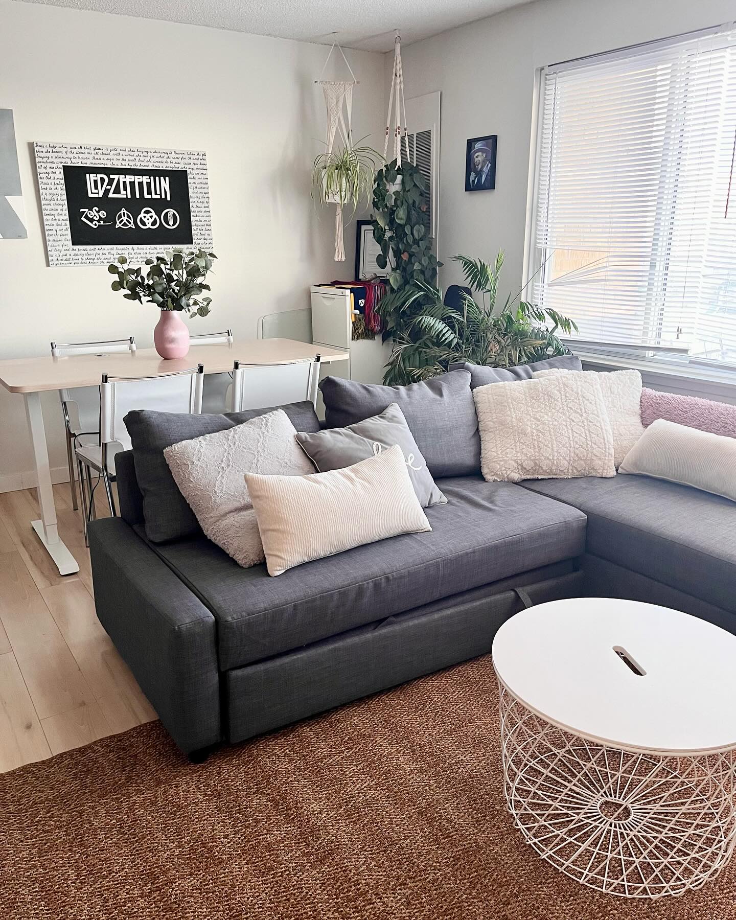 Restyled Winnipeg living room with a sectional, rug, and layered pillows after a no-renovation redesign