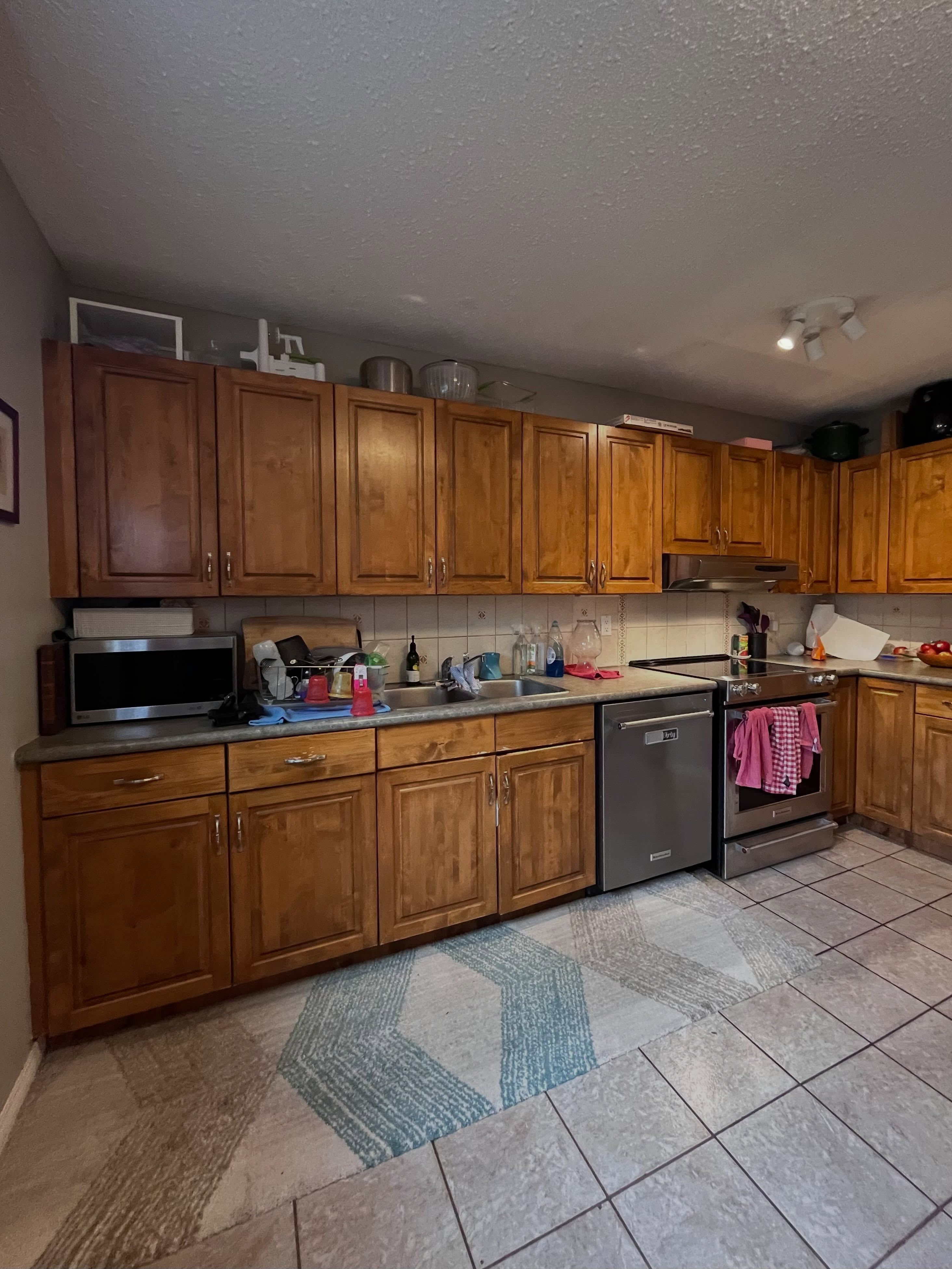 Winnipeg kitchen before renovation with honey oak cabinets, laminate counters, and a stainless range