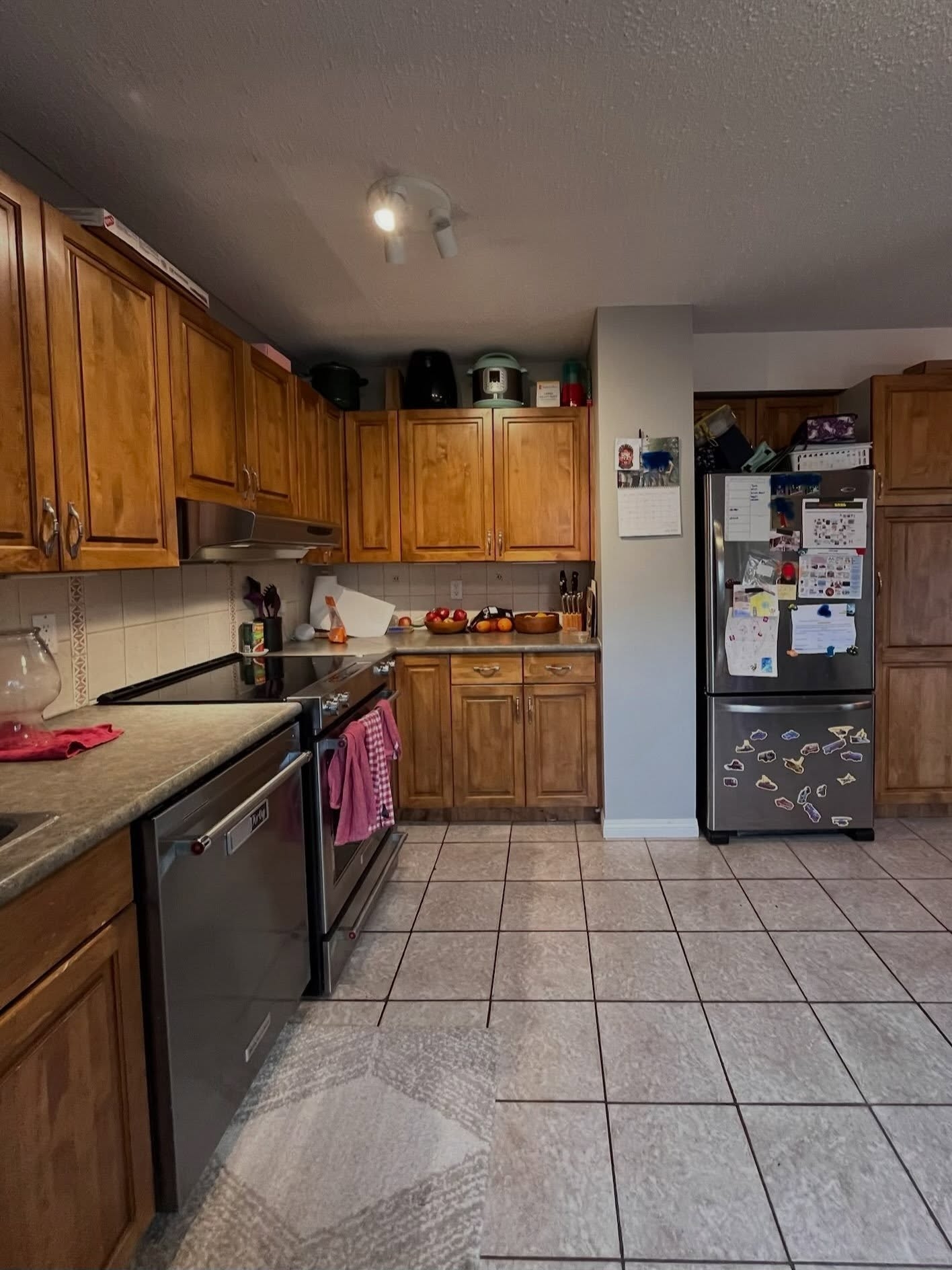 Winnipeg kitchen before renovation showing the appliance wall and older oak cabinetry
