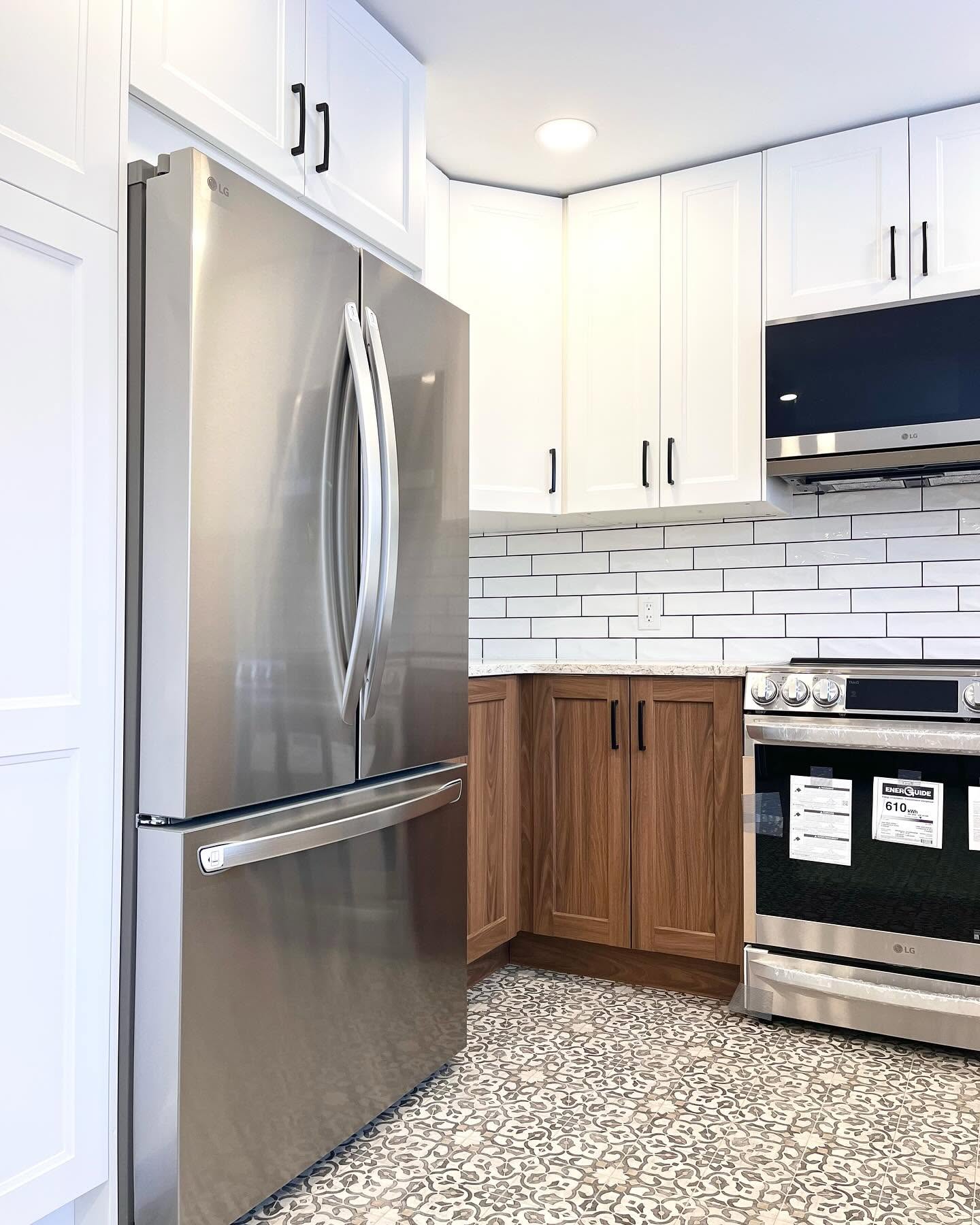 Finished Project Hydrangea kitchen with white upper cabinets, wood lower cabinets, and patterned floor tile